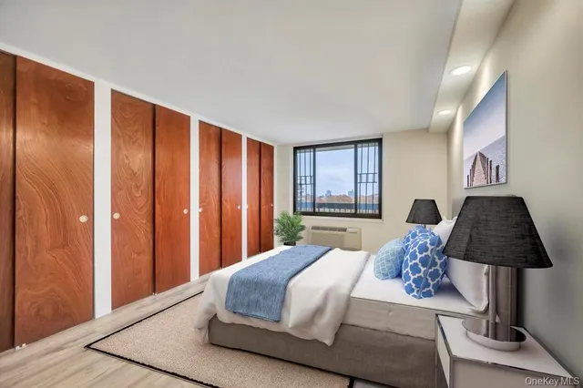 a bedroom with a large bed and a window