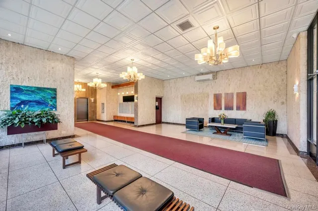 a room with lots of furniture and chandelier