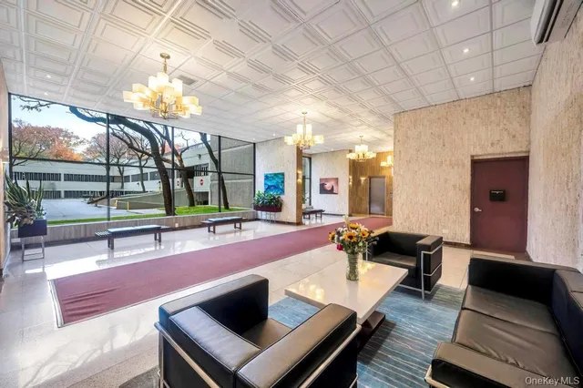 a lobby with furniture and a rug