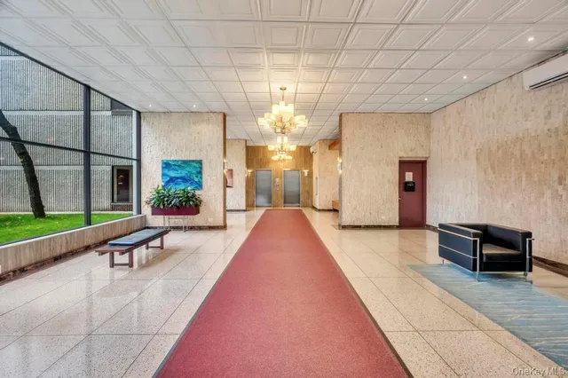 a lobby with furniture and window