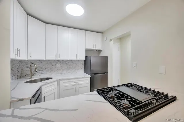 a kitchen with a stove and a refrigerator