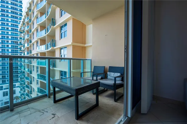 a view of balcony with a potted plant and wooden fence