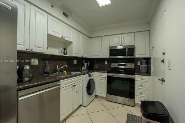 a kitchen with stainless steel appliances granite countertop a stove and a microwave