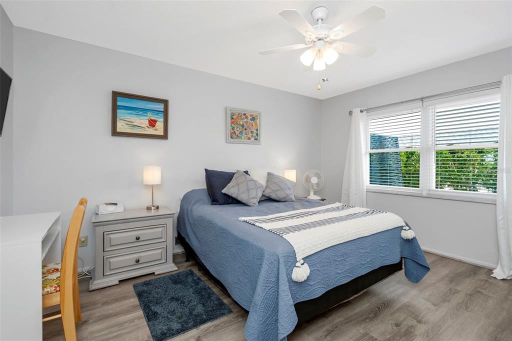 9617 Brassie Court New Port Richey, FL 34655 - Photo 16 of 41 a bedroom with a large bed and a chandelier