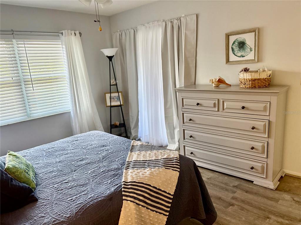 9617 Brassie Court New Port Richey, FL 34655 - Photo 19 of 41 a bedroom with a bed and a dresser