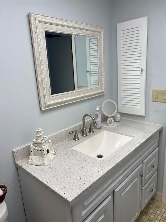 9617 Brassie Court New Port Richey, FL 34655 - Photo 26 of 41 a bathroom with a sink and a mirror
