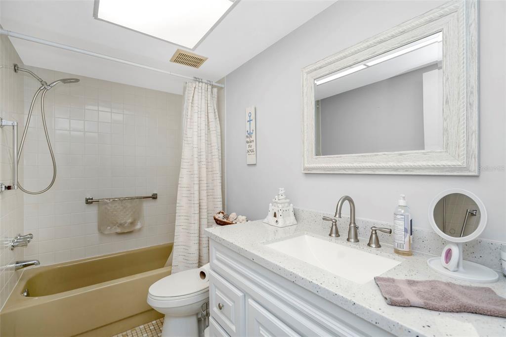 9617 Brassie Court New Port Richey, FL 34655 - Photo 27 of 41 a bathroom with a granite countertop sink mirror vanity and toilet
