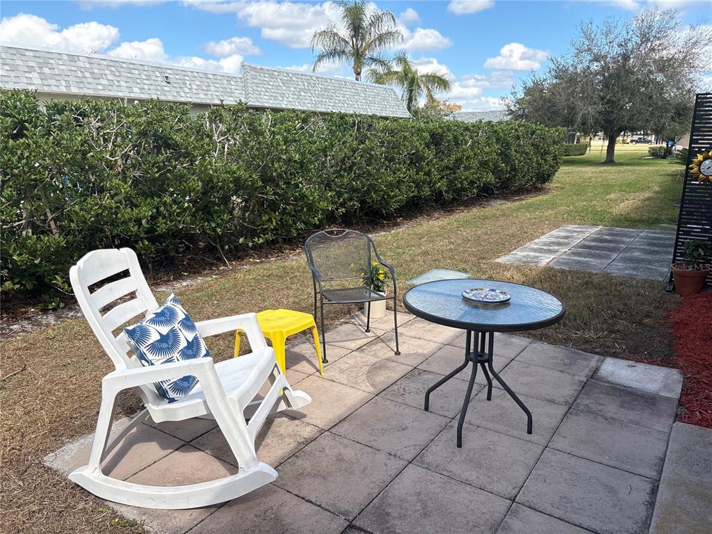 9617 Brassie Court New Port Richey, FL 34655 - Photo 32 of 41 a view of a swimming pool with a chairs and table in the patio