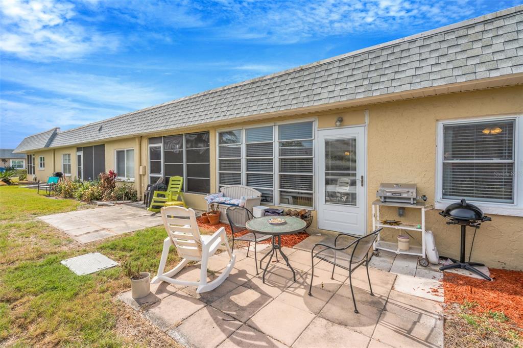 9617 Brassie Court New Port Richey, FL 34655 - Photo 33 of 41 a view of a patio with table and chairs and potted plants