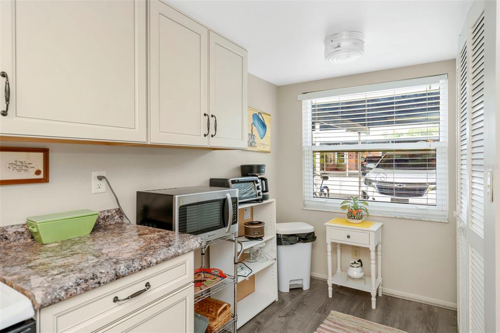 9617 Brassie Court New Port Richey, FL 34655 - Photo 5 of 41 a kitchen with a stove a sink and a microwave