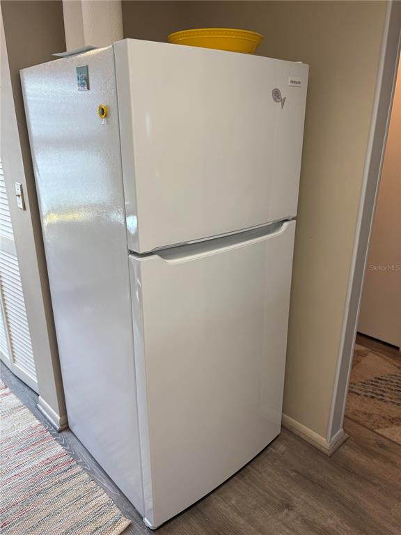 9617 Brassie Court New Port Richey, FL 34655 - Photo 8 of 41 a white refrigerator freezer and a wooden floor