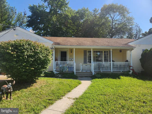 a view of a house with a yard and a garden
