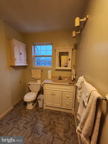 a bedroom with bed and wooden floor