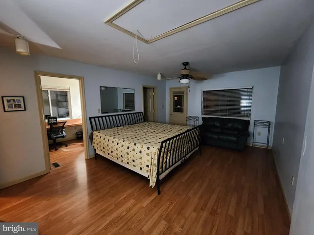a view of a hallway and a livingroom with furniture