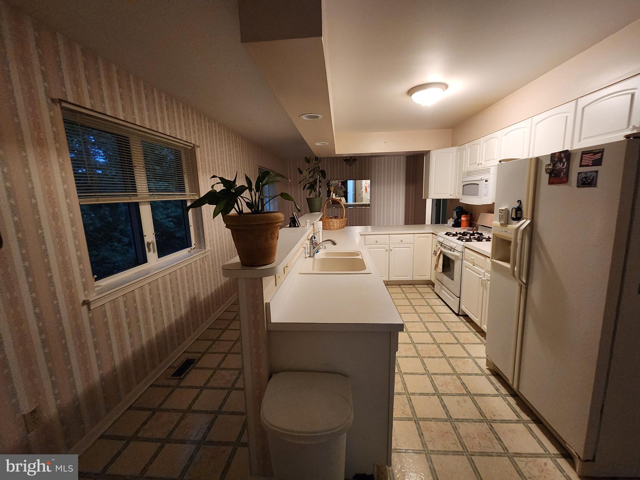 22 Theodore Avenue Maple Shade, NJ 08052 - Photo 18 of 33 a kitchen with stainless steel appliances a refrigerator a sink a stove top oven a counter space and cabinets