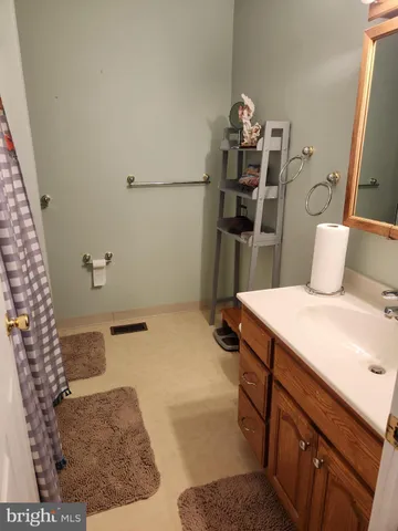 a bathroom with a double vanity sink toilet and a mirror
