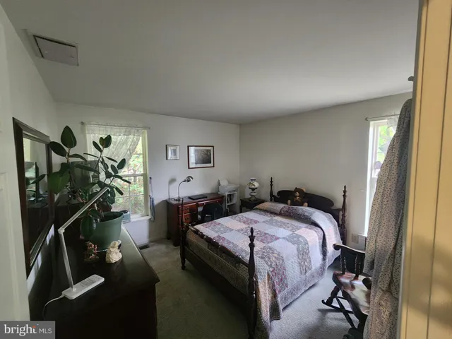 a bathroom with a sink vanity granite and toilet