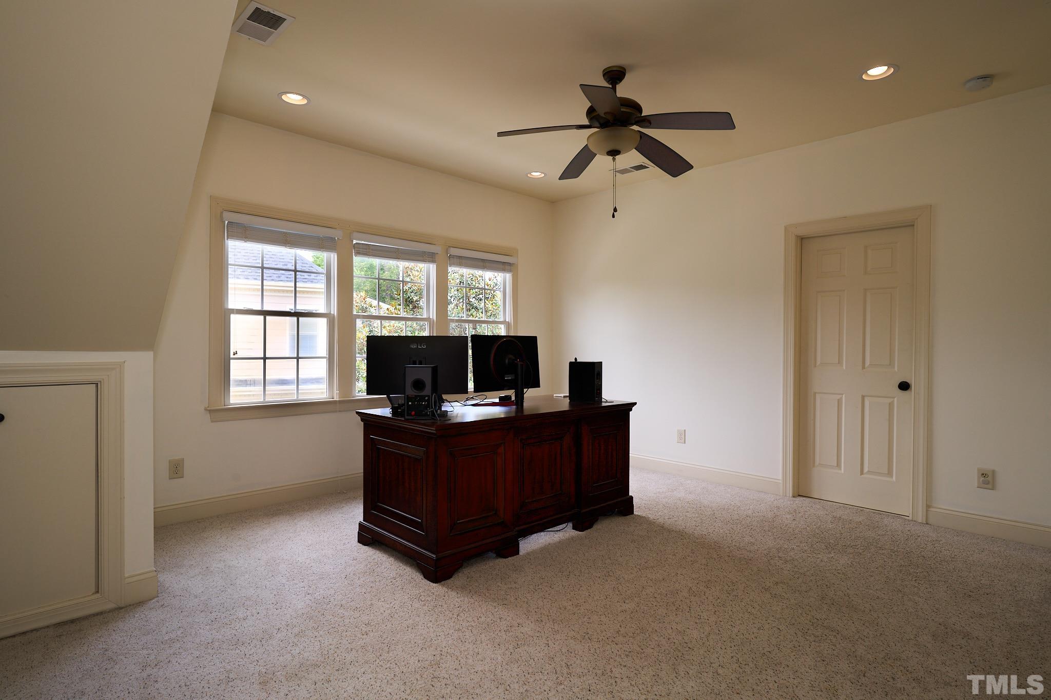 424 Waterville Street Raleigh, NC 27603 - Photo 42 of 76 a living room with furniture and a flat screen tv