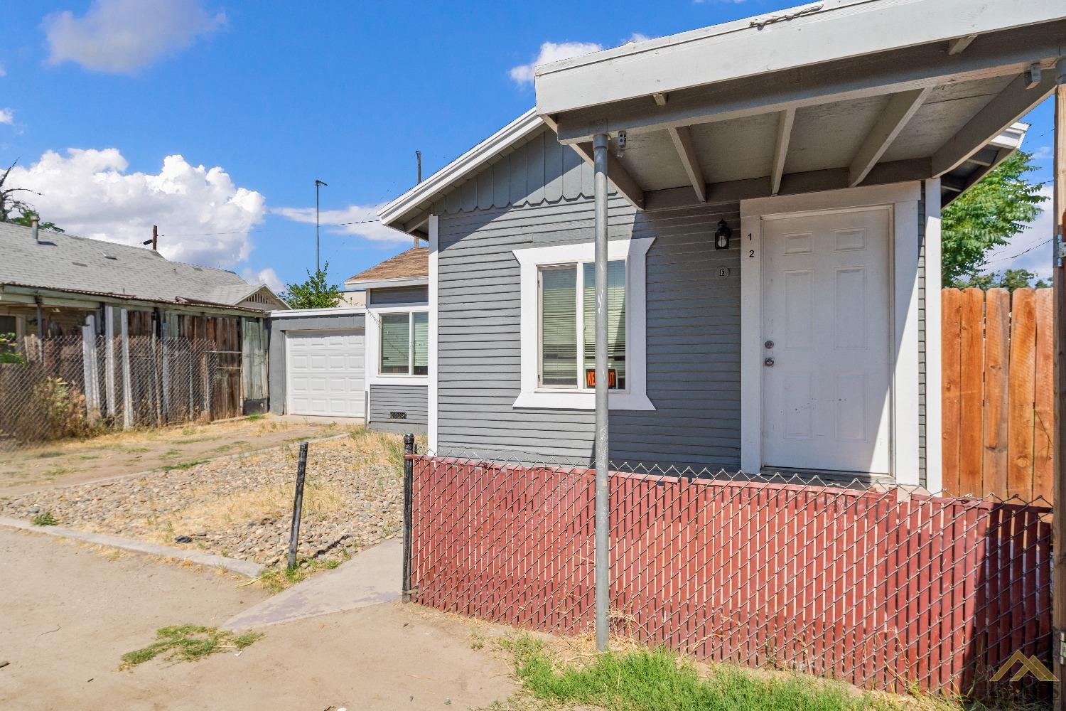 Undisclosed Address Bakersfield, CA 93308 - Photo 2 of 12 a front view of a house with garden