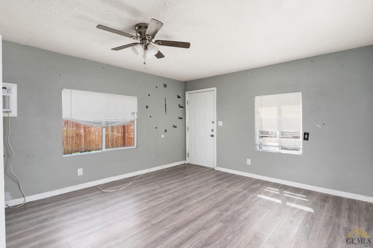 Undisclosed Address Bakersfield, CA 93308 - Photo 3 of 12 wooden floor in an empty room with a window