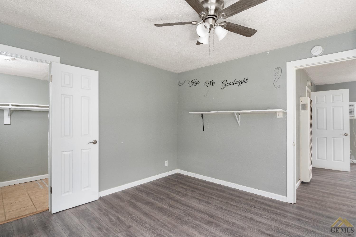 Undisclosed Address Bakersfield, CA 93308 - Photo 5 of 12 an empty room with wooden floor closet and windows