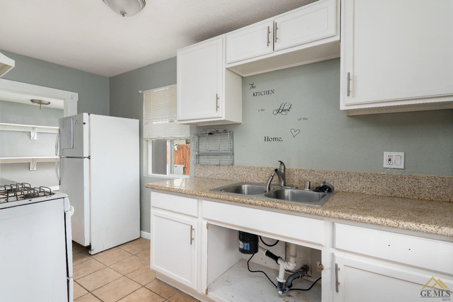 Undisclosed Address Bakersfield, CA 93308 - Photo 7 of 12 a kitchen with stainless steel appliances granite countertop a sink stove and refrigerator