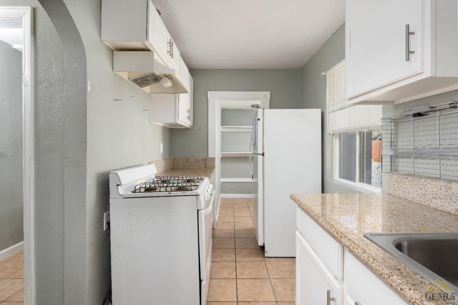 Undisclosed Address Bakersfield, CA 93308 - Photo 8 of 12 a kitchen with a stove and a refrigerator