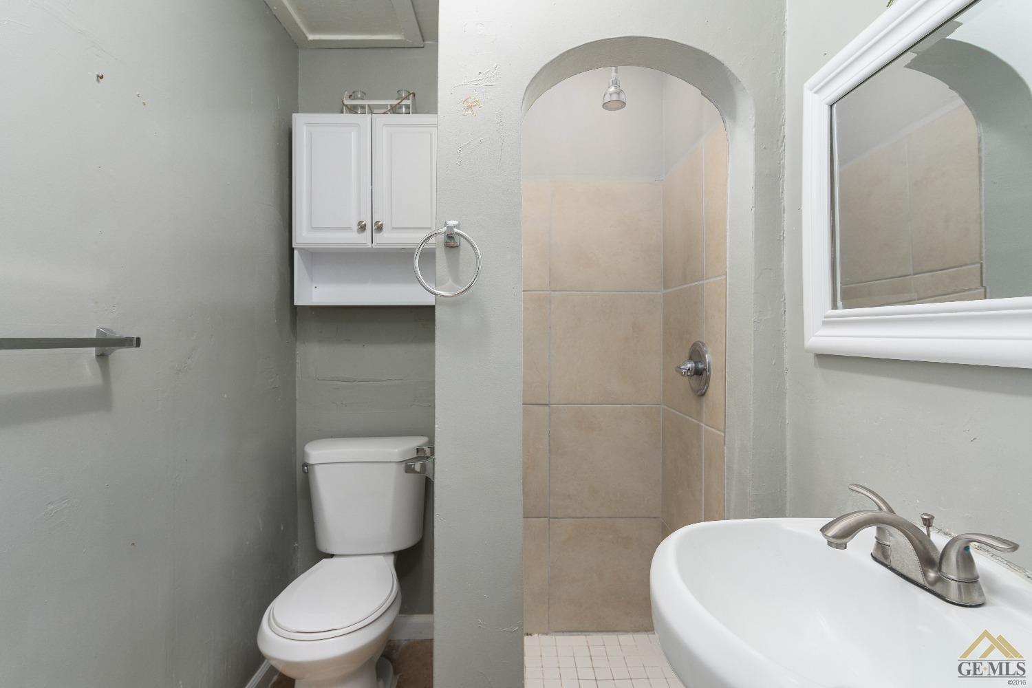 Undisclosed Address Bakersfield, CA 93308 - Photo 9 of 12 a bathroom with a toilet sink and mirror