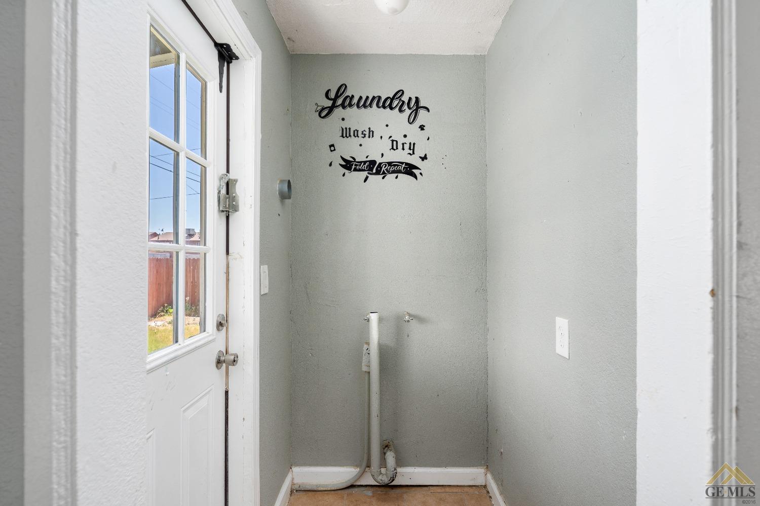 Undisclosed Address Bakersfield, CA 93308 - Photo 10 of 12 a view of a hallway with paintings on the wall