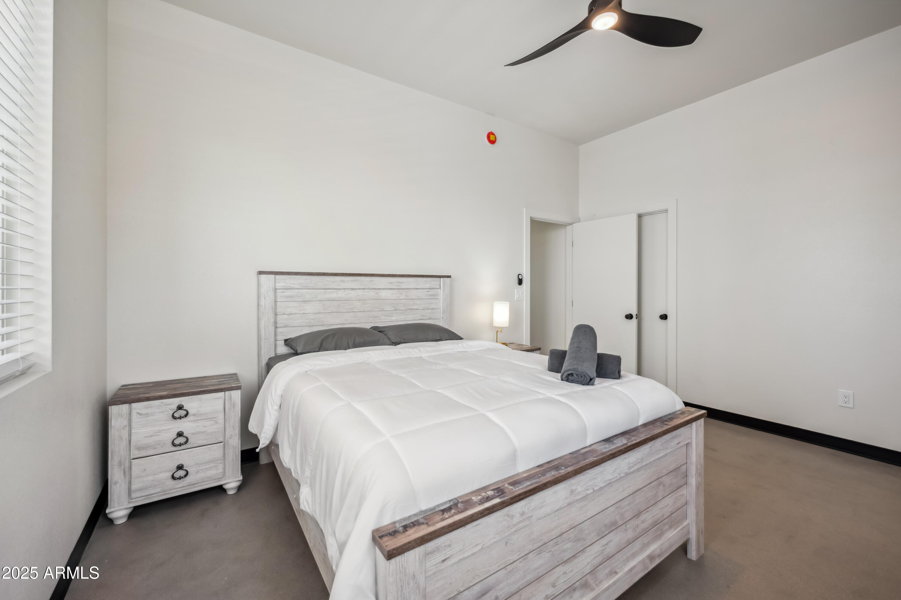 4132 North 11th Street Phoenix, AZ 85014 - Photo 27 of 33 a bedroom with a bed and a chandelier