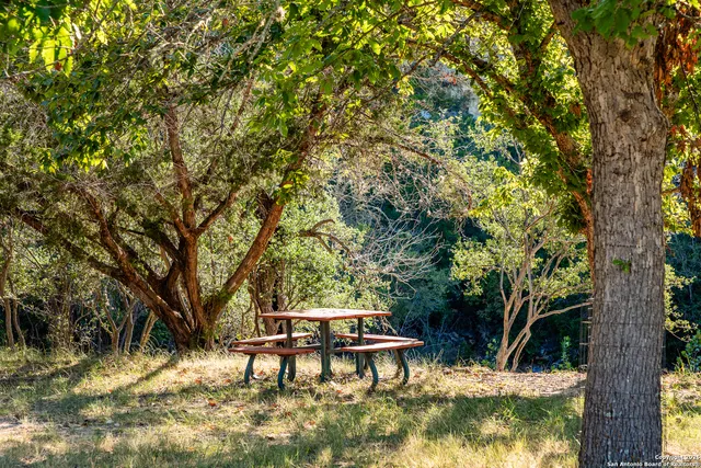 a view of backyard with a table and chairs