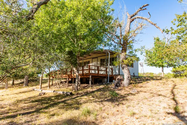 a backyard of a house with table and chairs