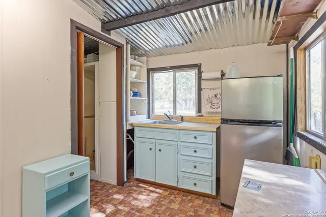 a kitchen with a refrigerator and a sink