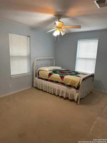 a bedroom with a bed table and window