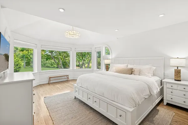 a spacious bedroom with a large bed and a large window