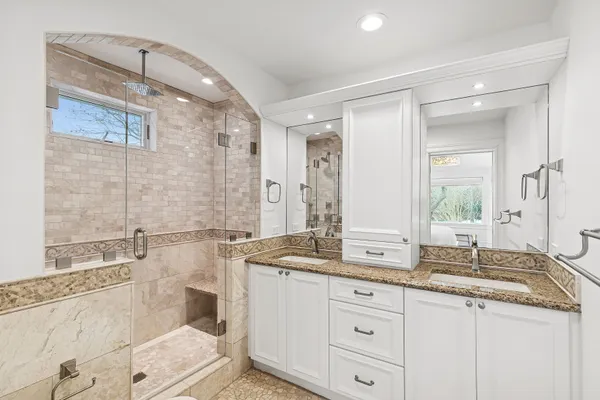 a bathroom with a granite countertop sink mirror and