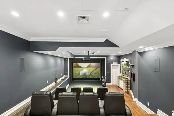 a room with furniture and a projector screen