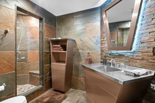 a bathroom with a sink toilet and shower