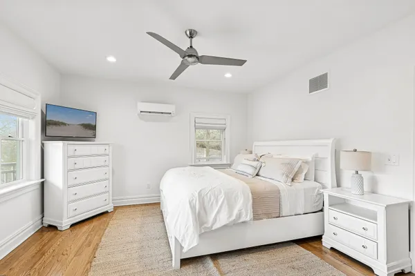 a bedroom with a bed and a dresser