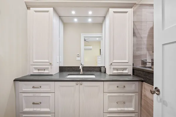 a bathroom with a sink and a mirror