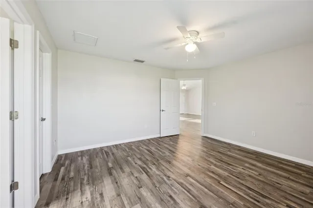 a view of an empty room and wooden floor