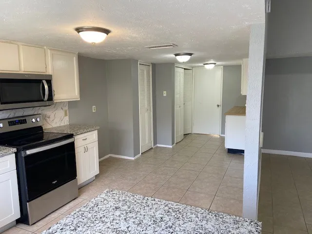 a view of a kitchen with electric appliances
