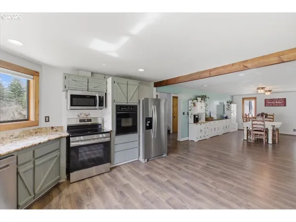 a view of a kitchen with a sink and a refrigerator