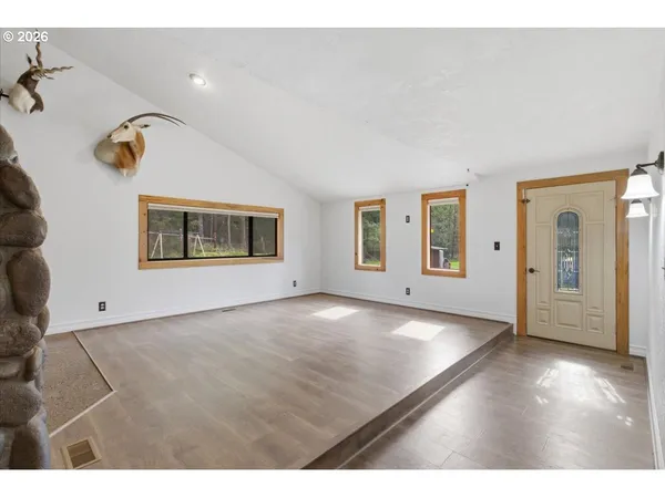 a view of a livingroom with wooden floor and window