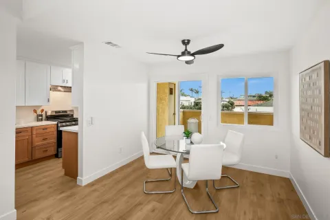 a kitchen with stainless steel appliances kitchen island granite countertop a table chairs and a refrigerator