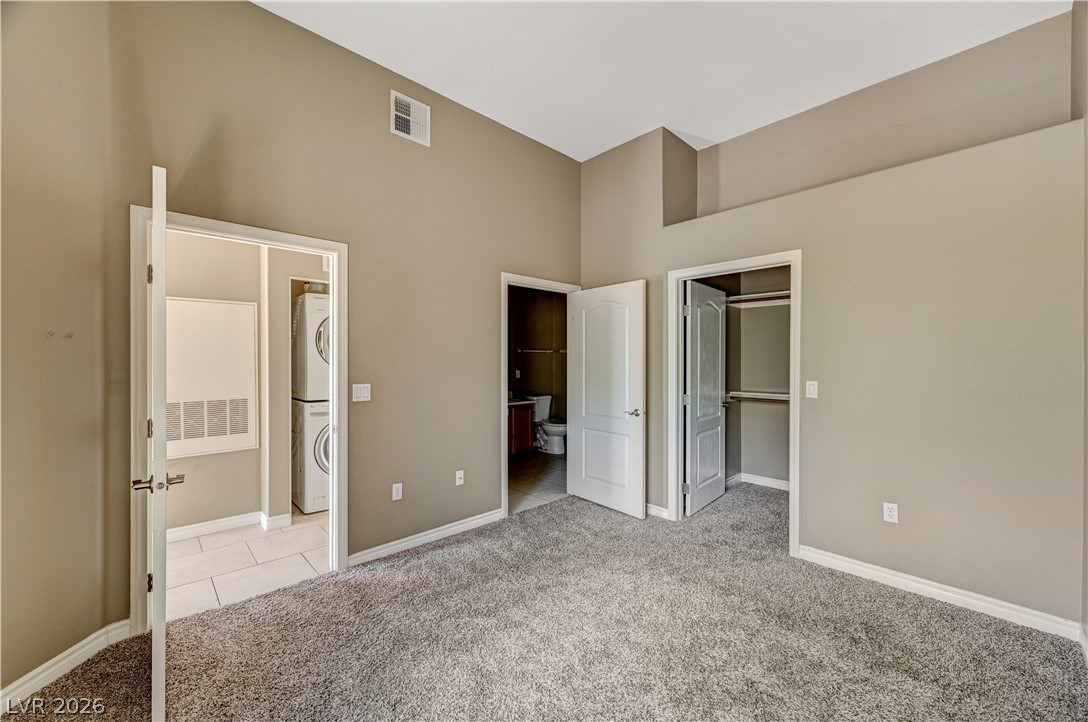 8985 South Durango Drive, Unit 2187 Las Vegas, NV 89113 - Photo 4 of 73 A comfortable bedroom with plush carpeting leads to a convenient laundry area and a well-appointed bathroom.