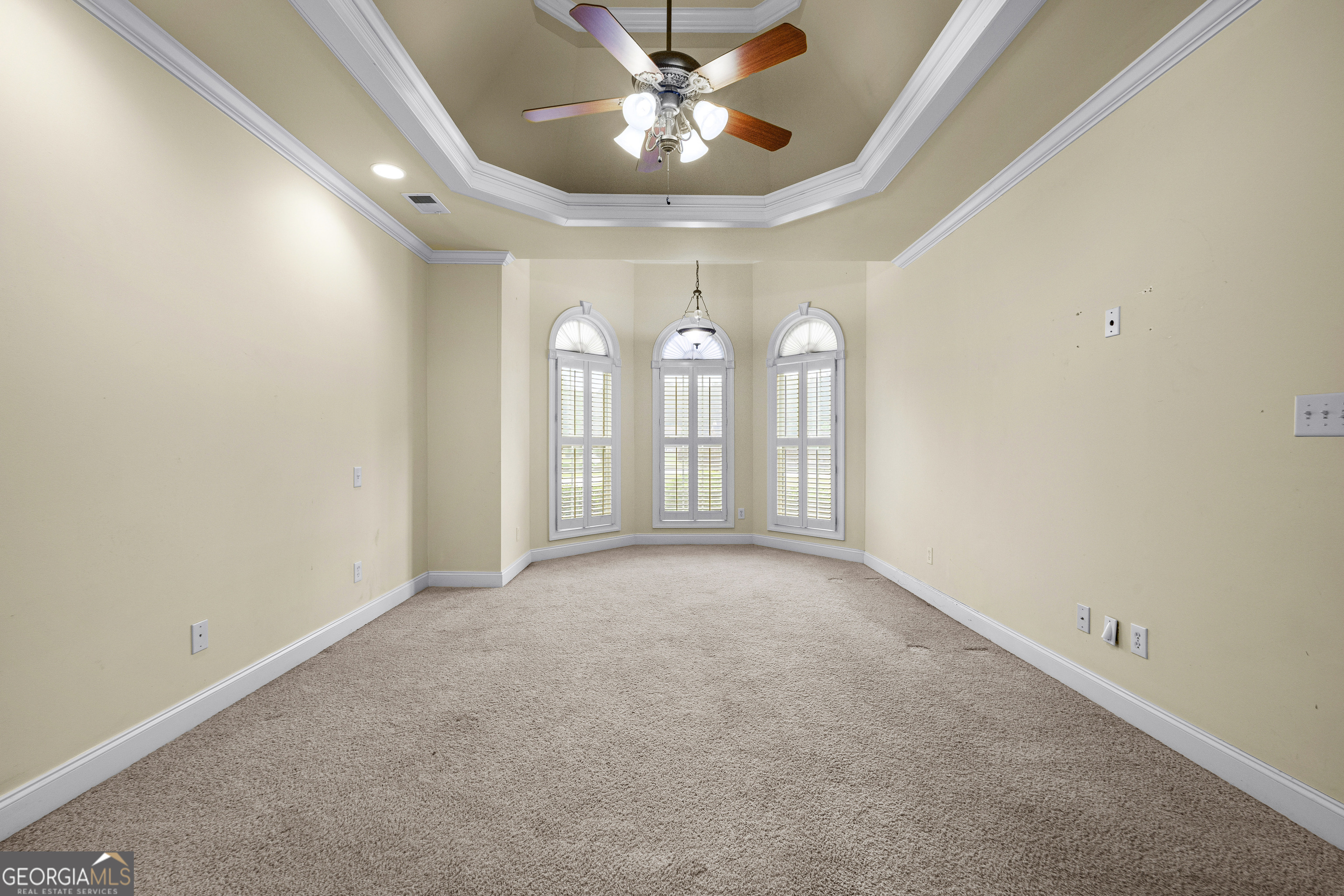 120 Shankhill Ridge Tyrone, GA 30290 - Photo 22 of 54 an empty room with a chandelier fan and windows