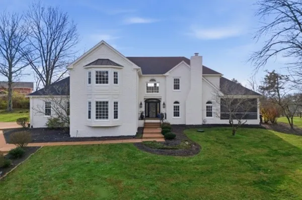 a front view of house with yard and green space