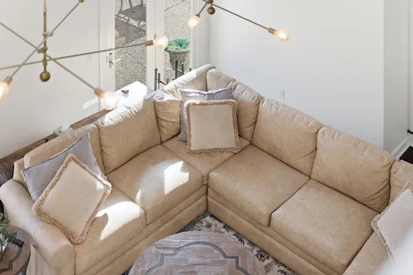 a kitchen with stainless steel appliances kitchen island granite countertop a table chairs and a refrigerator