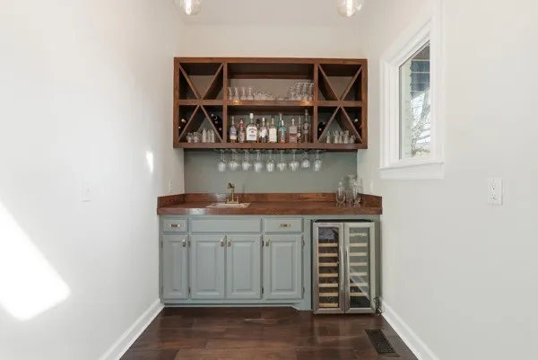 a kitchen with stainless steel appliances a dining table chairs stove and cabinets